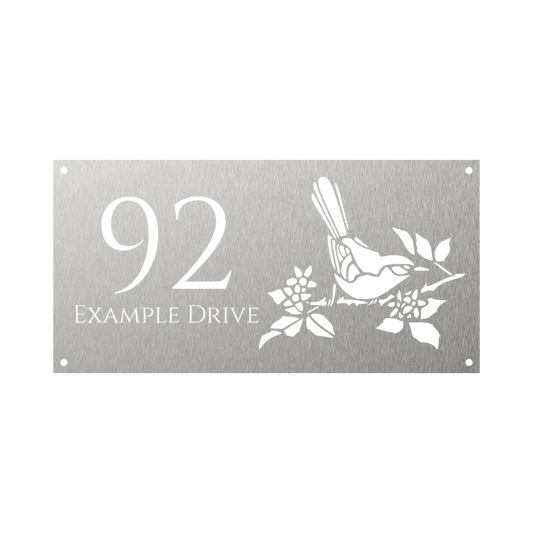 Rectangular steel house number with design of bird sitting on tree